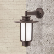 уличный настенный фонарь с цилиндрическим стеклянным плафоном и верхним козырьком направленный вниз