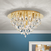 потолочная хрустальная люстра с плотным каскадом подвесок на широком золотистом основании