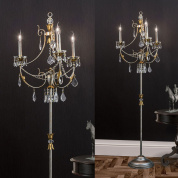 трёхламповая люстра с декоративными элементами и свечевидными плафонами в серебристо-золотой отделке